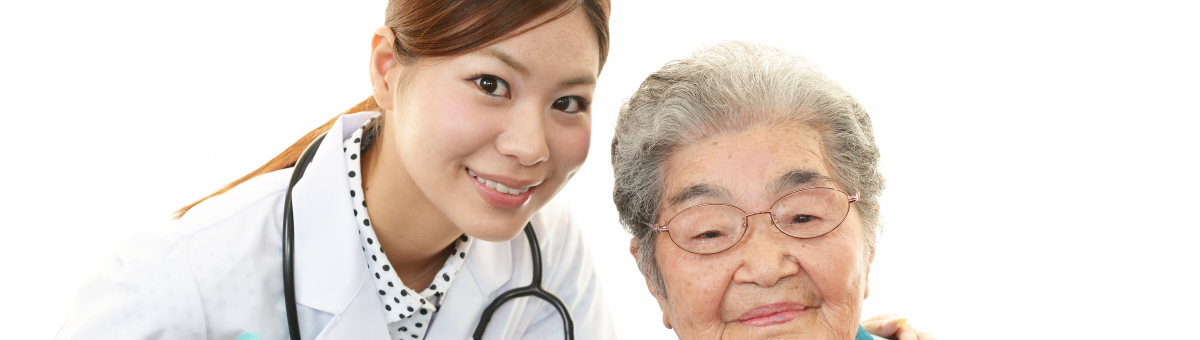 A healthcare worker standing beside an old lady