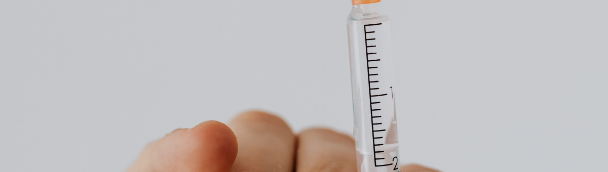 A person holding needle and syringe