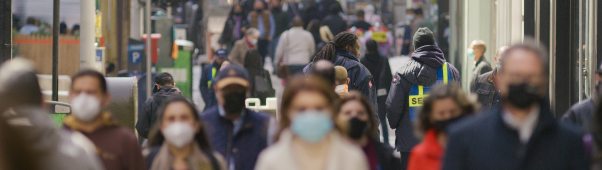 Anonymous Crowd Of People Walking Wearing Masks